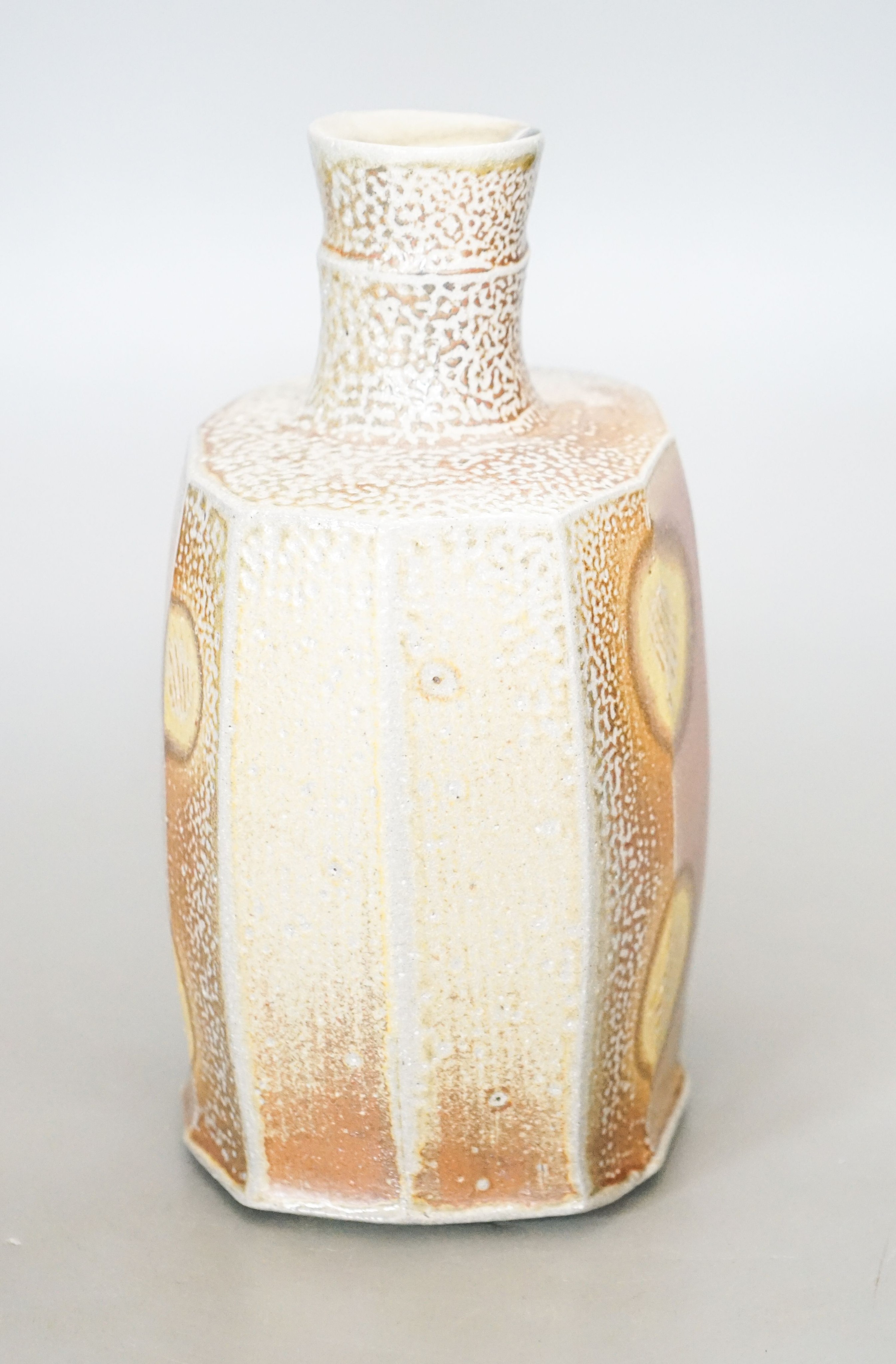 Phil Rogers (1951-2020), a faceted bottle 21cm